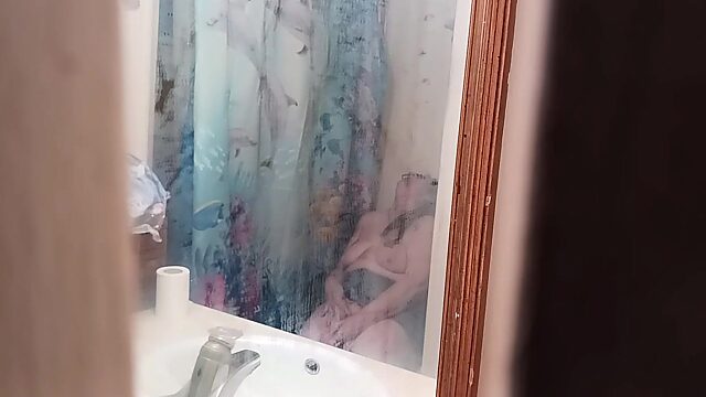 Surprised stepmom pleasuring herself in bathroom