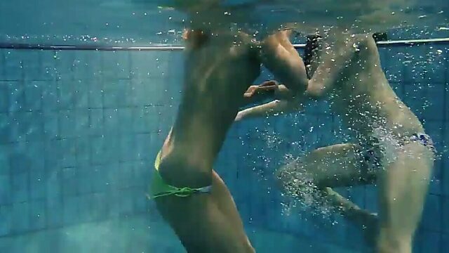 Two underwater babes flaunting their hot bodies